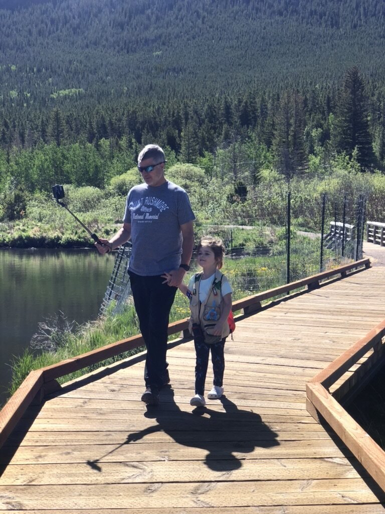 Mark with his granddaughter on a mountain boardwalk