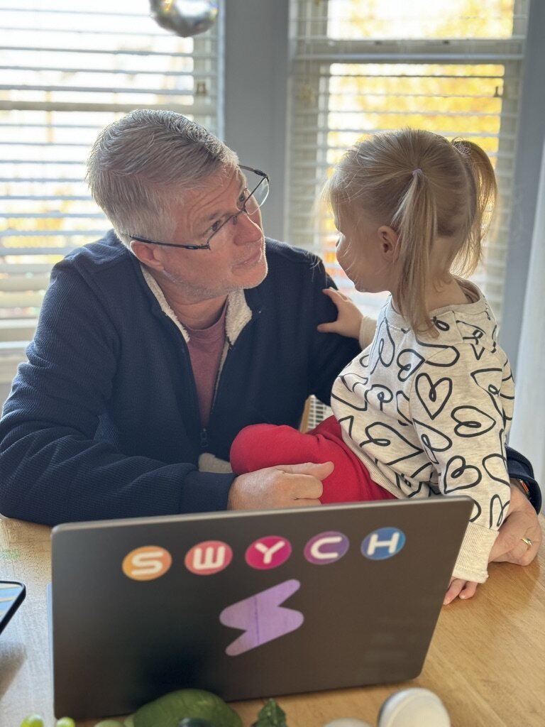 Mark with his granddaughter at the SWYCH laptop