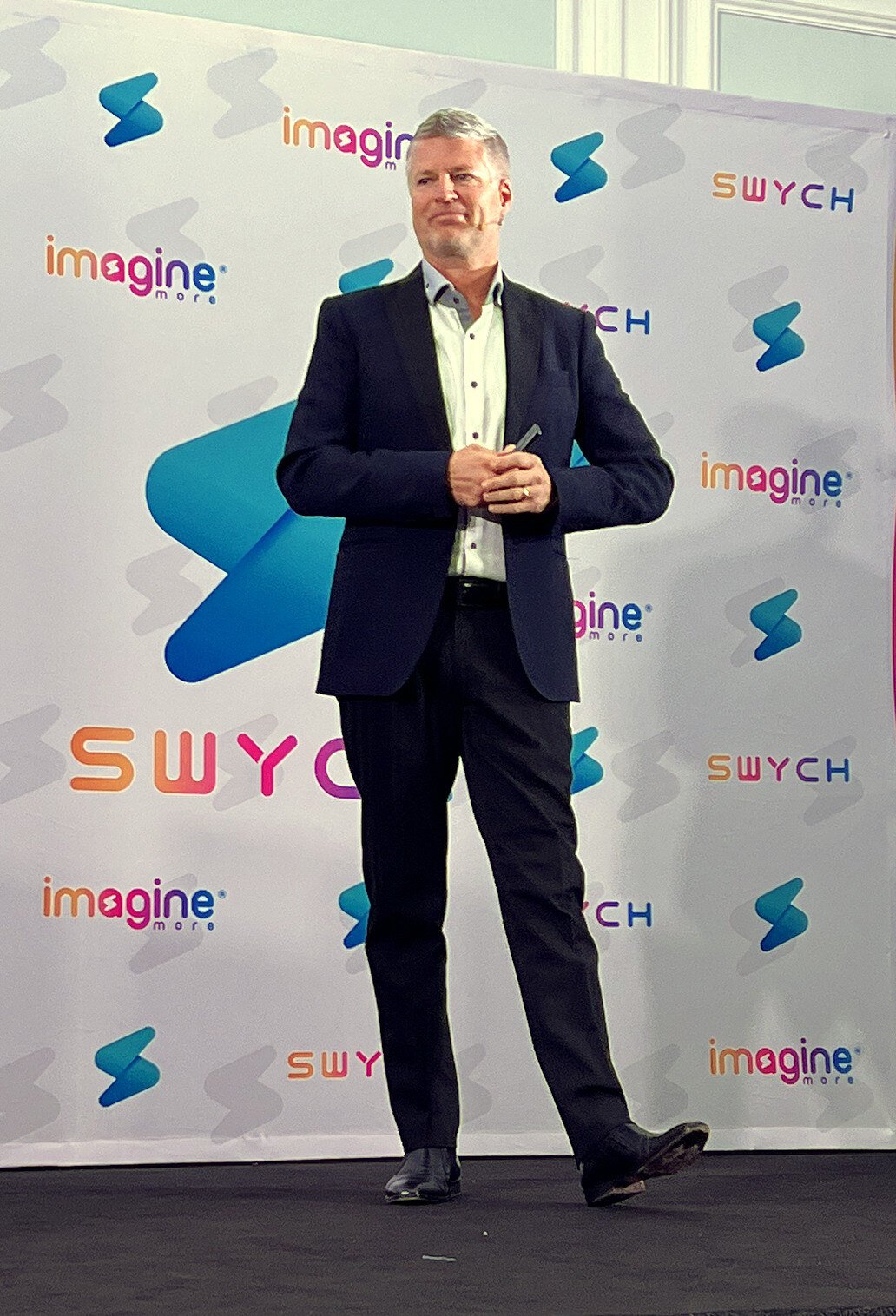 Mark McCool speaking on stage at a SWYCH event